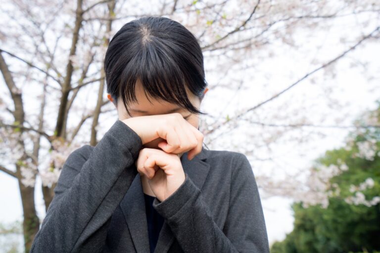 Young businesswoman crying under the cherry blossoms